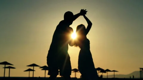 Couple dancing on the beach / Sunset silhouettes Stock Footage 65111256