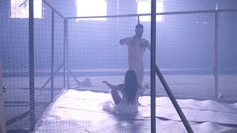 Couple dancing behind the net Stock Footage 143690372