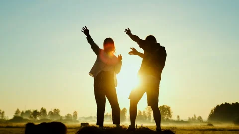 A couple dancing funny on the haystack at sunrise morning (or sunset evening). Stock Footage 136221233