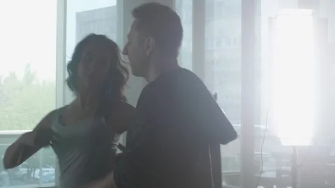 Couple dancing kizomba in front of bright led panels Stock Footage 107477381