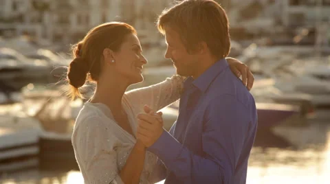 Couple dancing by Marina in evening light Stock Footage 43618432