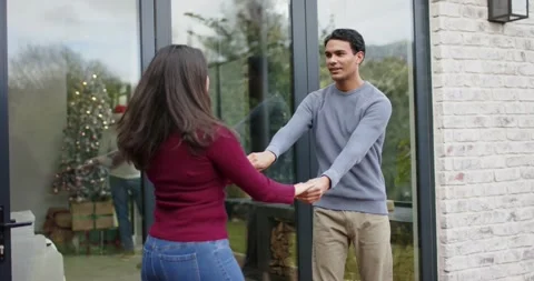 Couple dancing on patio with man reaching through sliding door and embracing to Stock Footage 336535168
