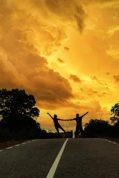 Couple dancing on the road under the moon Stock Photos