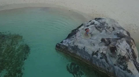 Couple dancing on rocks at beach Stock Footage 67615242