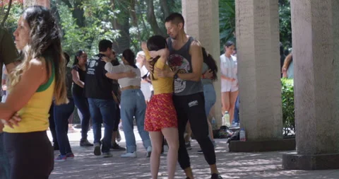 Couple Dancing Salsa in Mexico City Shaded Park with Other Dancers Nearby Stock Footage 331775657