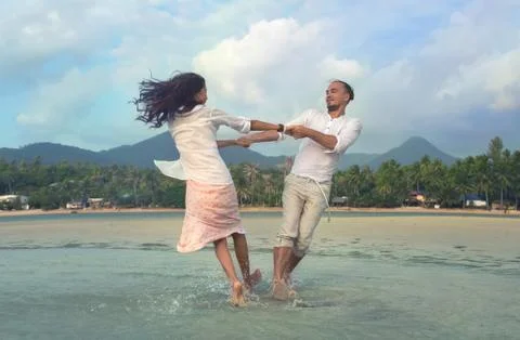 Couple dancing on the sand beach Stock Photos
