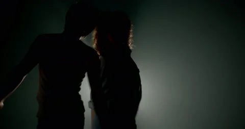 Couple dancing in silhouettes Stock Footage