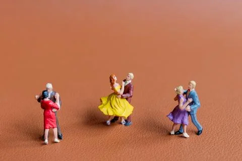 Couple dancing on a smooth brown background Stock Photos