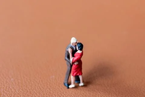 Couple dancing on a smooth brown background Stock Photos