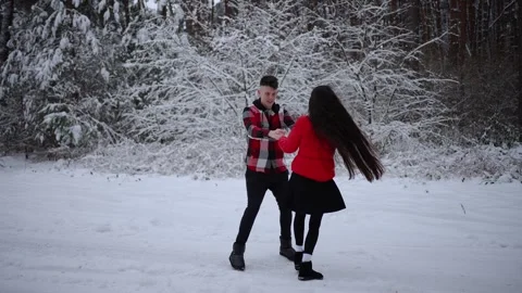 Couple dancing in snowy forest during winter. Entertainment order concept. Stock Footage 287820186