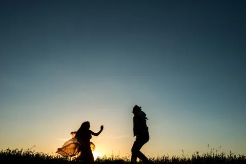 Couple dancing in the sunset Stock Photos