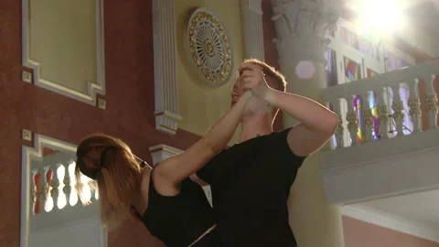 A couple dancing tango. Young couple dancing the tango at the dance hall. Stock Footage 91768211