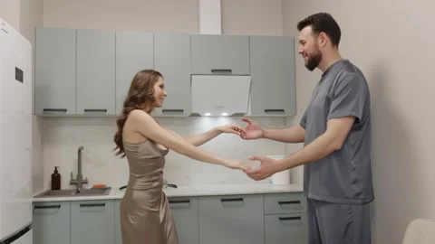 Couple dancing together in kitchen, joyful relationship Stock Footage 329242846