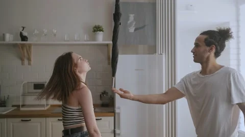 Couple dancing with umbrella at home Video stock 158156016