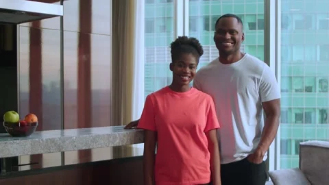 A couple of dark-skinned lovers look at the camera and smile, in the middle Stock Footage 267417054
