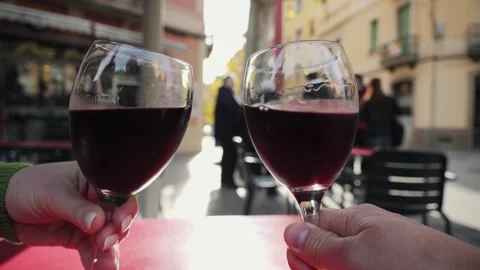 A couple on a date on a cafe terrace drinking red wine celebrating, having fun Stock Footage 327205042