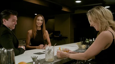 Couple Date Night at a Bar While Female Bartender Serves Cocktails Stock Footage 93157996