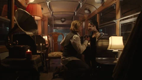 A couple on a date in an old tram talking to each other while man is kneeling Stock Footage 259177758