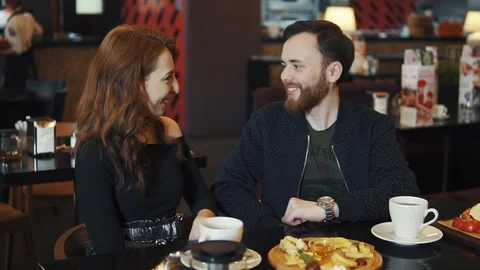 Couple on a date in a restaurant. young guy and girl have fun talking while Stock Footage 91087683