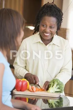 Couple with daughter preparing meal,mealtime Stock Photos