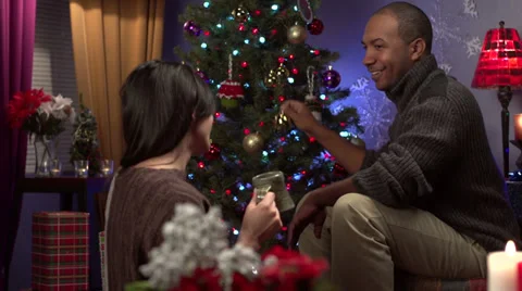 Couple decorating a Christmas tree Stock Footage 31965195