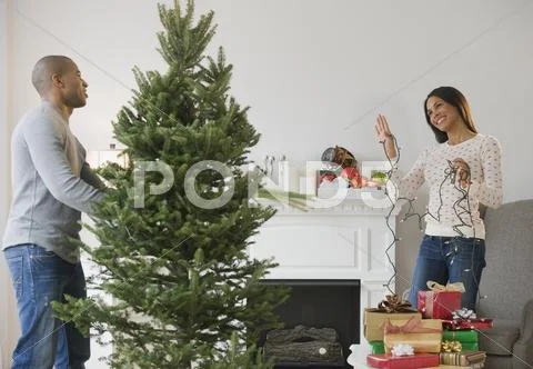 Couple Decorating Christmas Tree