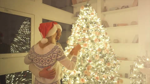 The couple decorating the christmas tree. slow motion Stock Footage 99142422