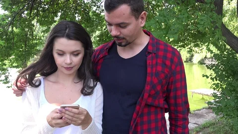 Couple devotion issues woman wired online on smartphone upset boyfriend breakup  Stock Footage 91521739