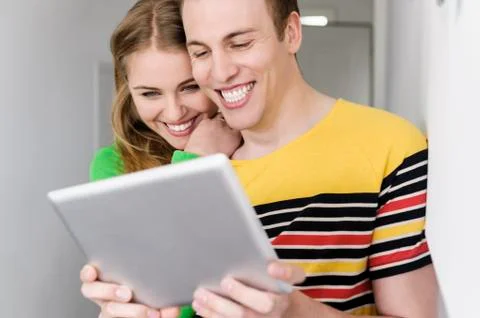Couple with digital tablet, smiling Stock Photos