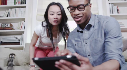 Couple with digital tablet technology. Student house accommodation. Flat share Vídeo Stock 32938800