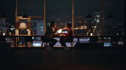 Couple dining cozy restaurant with night city view. Happy spouses talking date Stock Footage 340110364