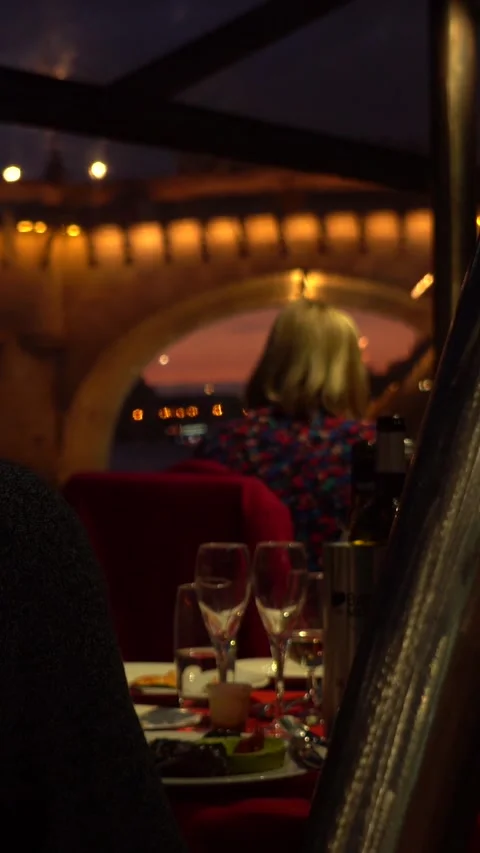 Couple Dining at Night by Illuminated Bridge, City Lights Reflected in River Stock Footage 334945467