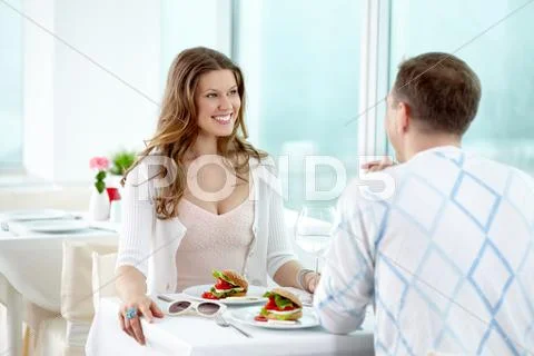 A couple dining out, looking at each other and smiling Stock Photos