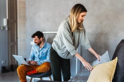 A couple disconnection as technology pulls the man away while the woman han.. Stock Photos