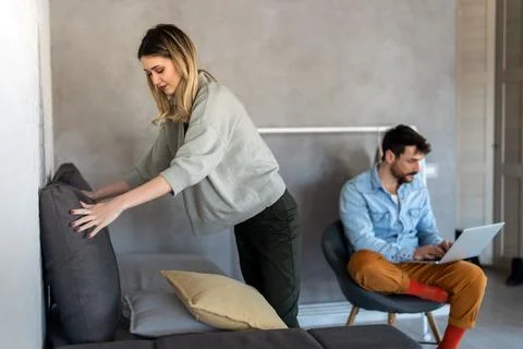 A couple disconnection as technology pulls the man away while the woman han.. Stock Photos