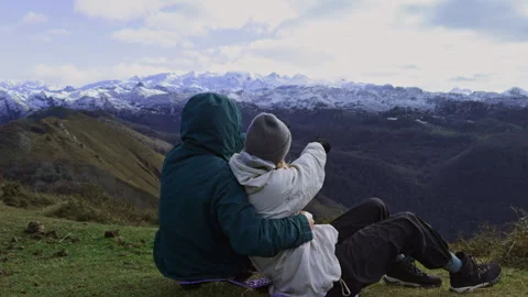 Couple discussing mountain scenery during outdoor picnic. 스톡 동영상 337653655