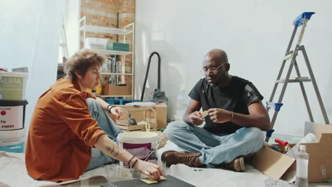 Couple Discussing Paint Samples and Sharing Home Renovation Ideas Stock Footage 269741632