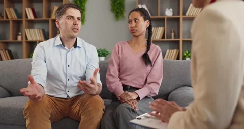 Couple discussing problems with therapist during relationship counseling session Stock Footage 337909435