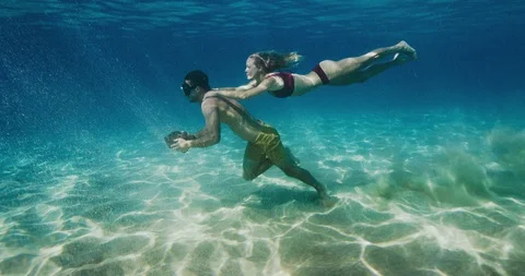 Couple does underwater workout together Stock Footage 105748862