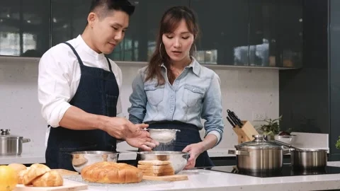 Couple doing bakery with sifting flour. Stock Footage 132336474