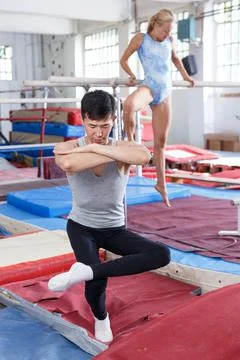 Couple doing exercises on parallel bars Stock Photos