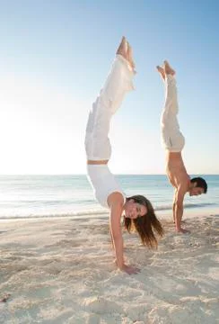 Couple doing Handstands on Beach, Reef Playacar Resort and Spa, Playa del Stock Photos