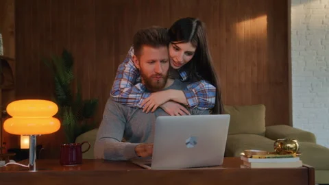 Couple doing online shopping using computer at home Stock Footage 266812912