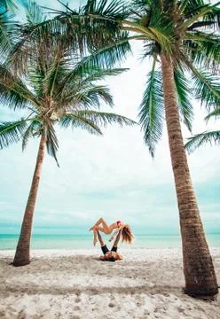 Couple doing Partner Acrobatics on th Beach in Florida Stock Photos
