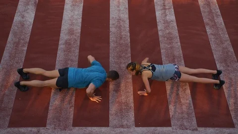 Couple doing push-ups together Stock Footage 100032538
