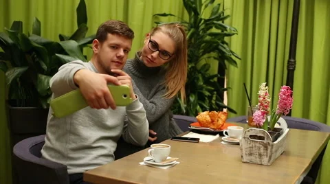 Couple doing selfie in the cafe  Stock Footage 65231169