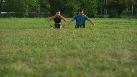 Couple doing stretching exercise outdoors Stock Footage 100033081