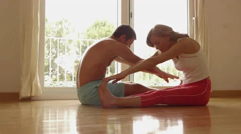 Couple doing stretching exercises together. Stock Footage 43657229