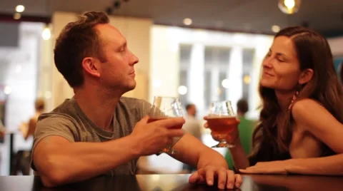 Couple Doing A Toast With Beer at a Bar Stock Footage 65997962