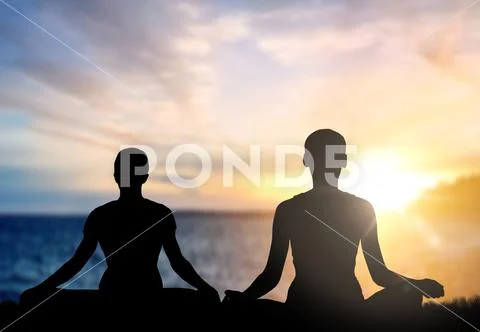 Couple doing yoga in lotus pose over sea sunset Stock Photos
